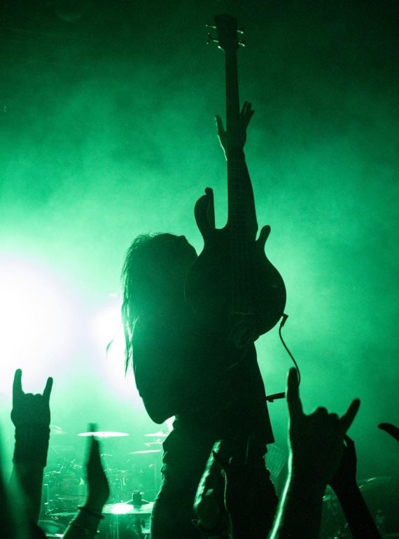 silhouette of people raising hands