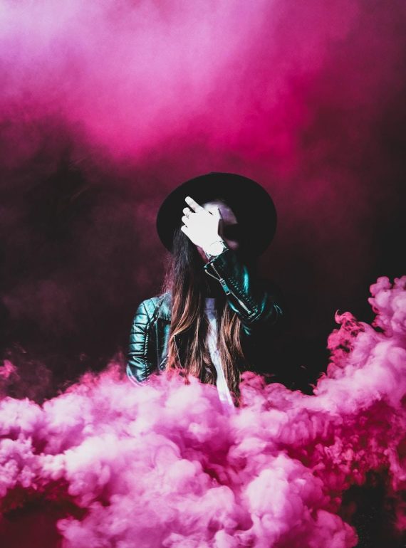 person standing around pink smokes